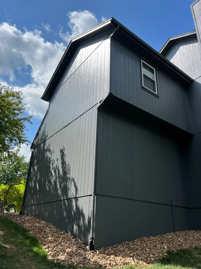 Charcoal board and batten siding with clean dark trim on a two-story Kansas City home